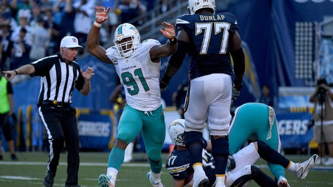 SAN DIEGO - NOVEMBER 13: Cameron Wake #91 of the Miami Dolphins celebrates his tackle of quarterback Philip Rivers #17 of the San Diego Chargers during the 2nd half of the Miami Dolphins v San Diego Chargers NFL Game at Qualcomm Stadium on November 13, 2016 in San Diego, California. (Photo by Donald Miralle/Getty Images)