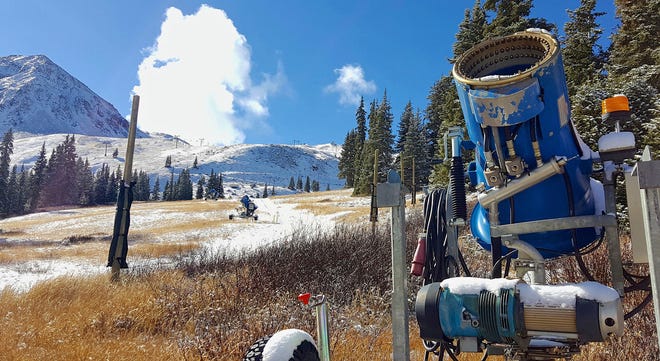 FILE - In this Nov. 2, 2016, file photo, a snow gun sits on an expanse of brown grass near the top of the Black Mountain Express run at Arapahoe Basin Ski Area near Keystone, Colo. Autumn snow has been scarce in the Rocky Mountains, forcing some ski areas to push back opening day and raising concerns about how much water will be available next spring for the Colorado River. But the first big storm of the season is expected to blow into Colorado and Utah on Thursday, Nov. 17, 2016. (Phil Lindeman/Summit Daily News via AP, File)