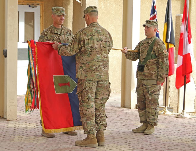 Maj. Gen. Joseph Martin, 1st Infantry Division and Fort Riley commanding general, and Command Sgt. Maj. Curt Cornelison, the division’s senior noncommissioned officer, uncase the “Big Red One” colors during the Transfer of Authority ceremony Nov. 17, 2016, in Baghdad, Iraq. (Spc. Anna Pongo, 1st Inf. Div. Public Affairs)