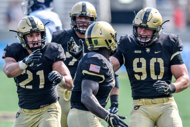 No need to explain Army's brotherhood to senior defensive lineman Eddy Ruzga (90). He gave up his starting spot against Air Force to Jordan Smith, who had battled back from an injury suffered during the spring. PHOTO PROVIDED BY PAT TEWEY