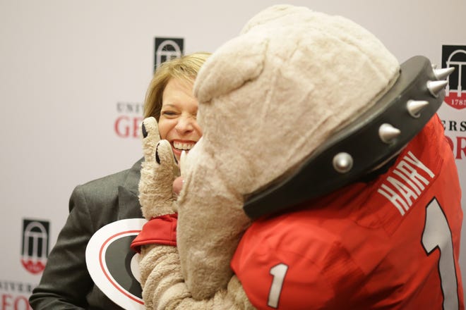 Leslie Gordon reacts as Hairy Dawg kisses her at a photo booth during the Commit to Georgia fundraising campaign held in the Tate Grand Hall at the University of Georgia, Thursday, November 10, 2016. (Photo/ John Roark, Athens Banner-Herald)