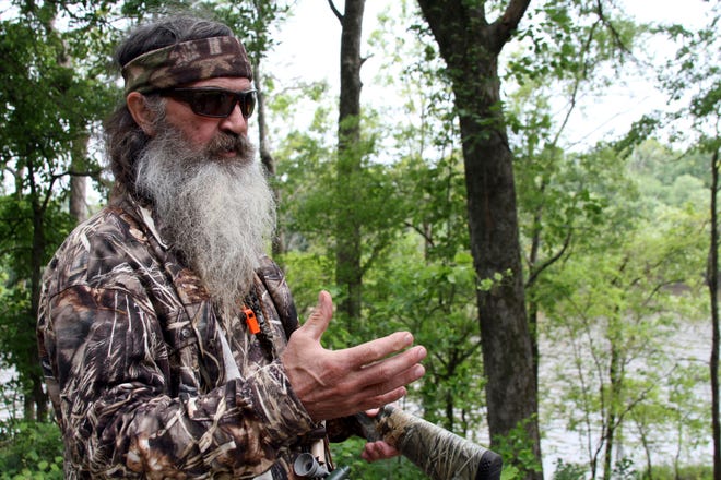 FILE - This May 15, 2013 file photo shows Phil Robertson, the family patriarch the Robertsons of the television series, “Duck Dynasty,” posing for a photograph at his home in western Ouachita Parish in Monroe, La. The “Duck Dynasty” family says its A&E series will end after this season. Their announcement was paired with the debut episode of the show’s 11th season on Wednesday, Nov. 16, 2016. (Margaret Croft/The News-Star via AP, File)