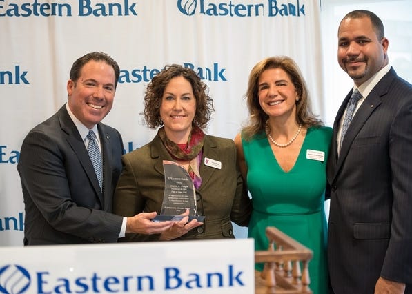 Eastern Bank recently presented Stacie Peugh with the bank's 2016 Community Advocacy Award. Peugh, president and CEO of YMCA Cape Cod, was recognized for her work in addressing vital needs in the local community through her work. The bank's charitable foundation made a $5,000 donation to YMCA Cape Cod. Shown (l to r), Robert Rivers, Eastern Bank president and CEO; Peugh; Rana Murphy, Eastern Bank SVP; Quincy Miller, vice chair and chief banking officer at Eastern. COURTESY PHOTO