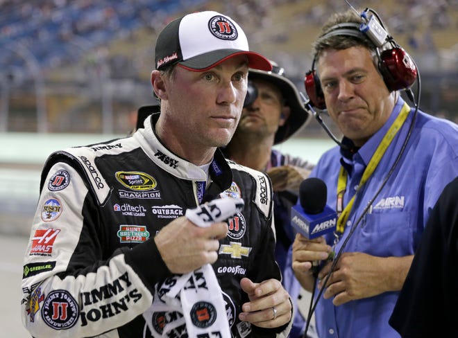 Kevin Harvick heads to the media center after qualifying for the NASCAR Sprint Cup Series auto race Friday, Nov. 18, 2016, in Homestead, Fla. Harvick won the pole. (AP Photo/Terry Renna)
