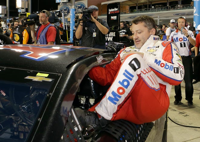 Race driver Tony Stewart gets in his car before NASCAR Sprint Cup Series Auto Racing qualifying Friday, Nov. 18, 2016, in Homestead, Fla. (AP Photo/Alan Diaz)