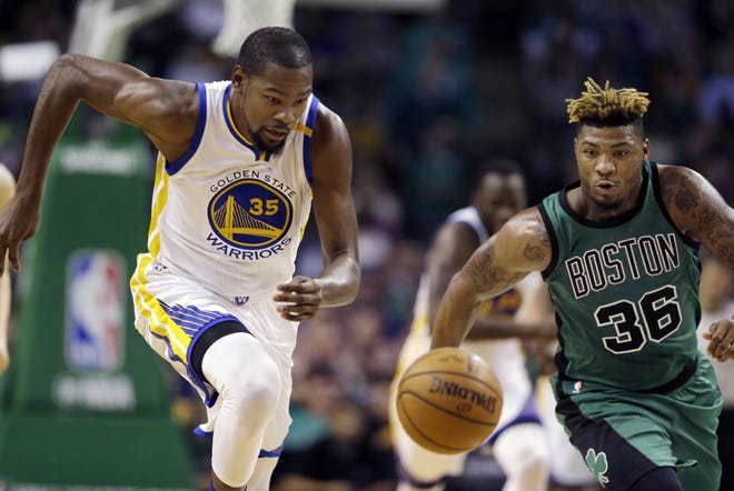 Golden State's Kevin Durant (35) and Boston guard Marcus Smart chase a loose ball during the third quarter of Friday night's game at TD Garden. AP Photo
