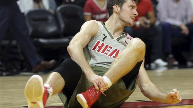Miami Heat's Goran Dragic (7) holds his left ankle after falling to the floor during the second half of an NBA basketball game against the Chicago Bulls, Thursday, Nov. 10, 2016, in Miami. (AP Photo/Lynne Sladky)