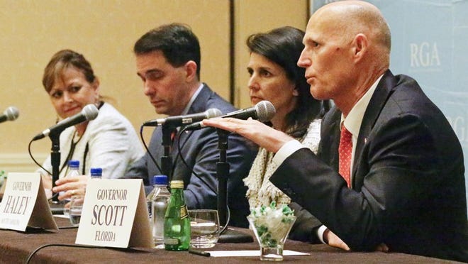 Florida Gov. Rick Scott, from right, and South Carolina Gov. Nikki Haley met with President-elect Donald Trump Thursday, Nov. 17, 2016 in New York. Here they attend the Republican Governors Association annual conference, Nov. 15, 2016, in Orlando, Fla. with, from left, New Mexico Gov. Susana Martinez and Wisconsin Gov. Scott Walker. (AP Photo/John Raoux)