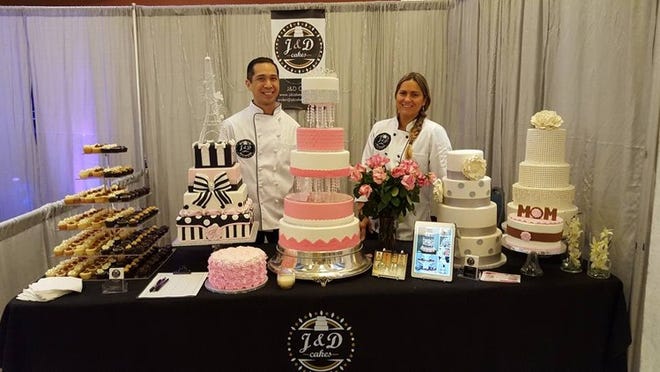 Joel Basco (left) and Daniela Borquez, of J&D Cakes in Boca Raton, stand in front of several cakes they baked and designed for a wedding. Basco and Borquez, winners of Food Network’s “Cake Wars,” opened their specialty bakery in October. (Contributed)
