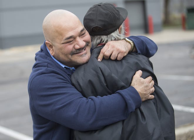 Oscar Murillo, owner of Oscar's Tires, hugs Raymond Vervinck, a customer for more than two years, near what's left of Oscar's Tires on Friday, Nov. 18, 2016. Vervinck gave Oscar $5 to help with rebuilding costs. "I know how it is to lose everything in a fire, and every bit helps," Vervinck said. Murillo started his business 13 years ago and considers his employees family. "I plan to reopen, might not be here but somewhere close by. This community depends on us," Murillo said. ARTURO FERNANDEZ/STAFF PHOTOGRAPHER/RRSTAR.COM