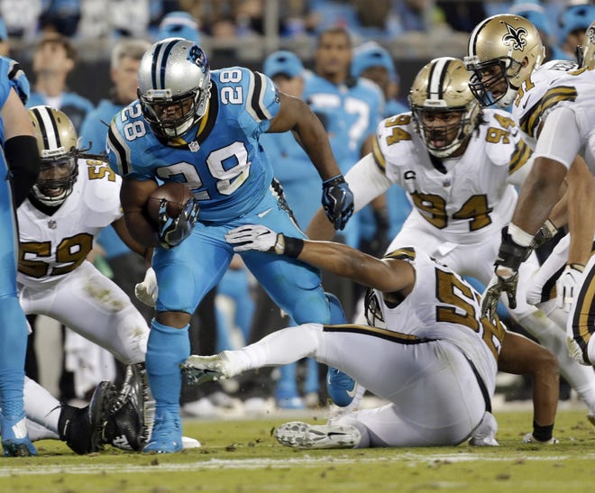 Carolina Panthers' Jonathan Stewart (28) breaks away from New Orleans Saints' Craig Robertson (52) in the second half of Thursday night's game in Charlotte, N.C. The Associated Press