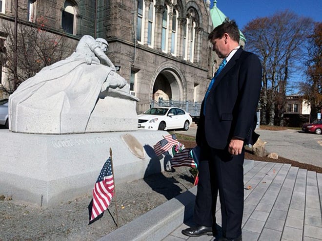 Christopher Fox reads the names engraved in Taunton's Korean Veterans War Memorial after walking up newly installed granite steps.
Taunton Gazette photo by Charles Winokoor