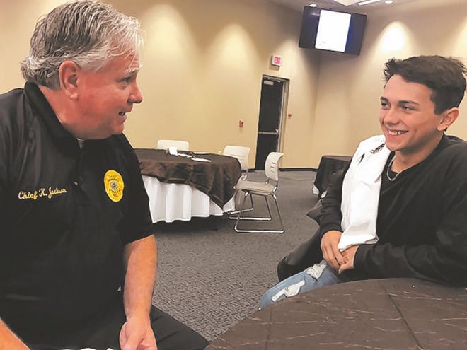 Swansboro Police Department Chief Ken Jackson laughs with 16-year-old Albert Aguilar, of Swansboro High School, at the Youth Partners with Law Enforcement event Friday. Photo by Amanda Thames / The Daily News