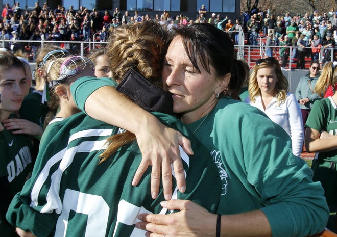 Oakmont field hockey coach Leanna Roy hugs goalie Morgan LeBlanc after Saturday's Division 2 state final loss to Watertown at WPI. Photo/Paul Connors