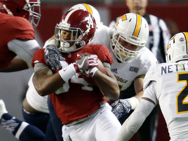 Alabama running back Damien Harris (34) is wrapped up by UT Chattanooga defenders as he runs up the middle in Bryant-Denny Stadium Saturday, November 19, 2016 Staff Photo/Gary Cosby Jr.