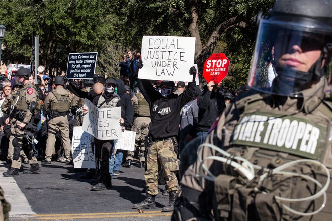 Police in riot gear hold counter-protestors away from a White Lives Matter rally in front of the Texas State Capitol in Austin, Texas, on Saturday, Nov. 19, 2016. Earlier in the day, officials unveiled a monument recognizing the contributions of African-Americans to the state. (Dave Creaney/Austin American-Statesman via AP)