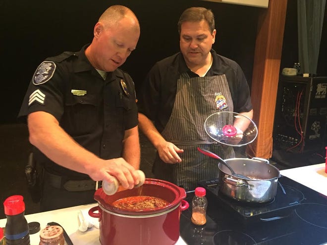 (From left) Sgt. Gary Johnson and Capt. Reid Brafford prepare chili during a living cooking demonstration at a chili cook-off between Gastonia police officers and firefighters at Hunter Huss High School on Sunday.

ADAM LAWSON/The Gazette