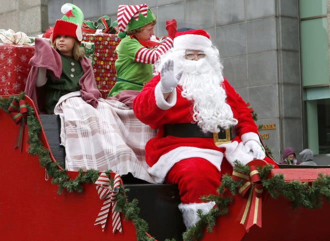 GLENN B. DETTMAN FOR THE INDEPENDENT

Santa Claus arrives on his sleigh Saturday morning with elves lending a helping during the 62nd Annual Holiday Parade in downtown Massillon.
