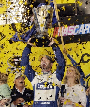 Jimmie Johnson celebrates at Homestead-Miami Speedway in Homestead, Fla., after winning his record-tying seventh NASCAR championship.