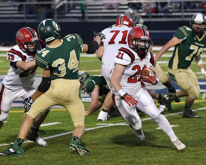 Photo by Jason Gendron

Wells' Evan Whitten finds a hole to run through thanks to the blocking of teammates Riley Dempsey, left, and David Ouellette (71).
