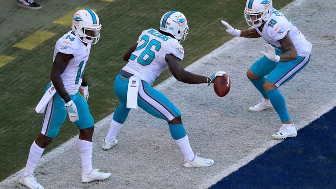 Damien Williams (26) celebrates a touchdown against the Chargers. (Getty Images)