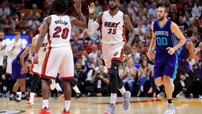MIAMI, FL - OCTOBER 28: Willie Reed #35 and Justise Winslow #20 of the Miami Heat high five during a game against the Charlotte Hornets at American Airlines Arena on October 28, 2016 in Miami, Florida. NOTE TO USER: User expressly acknowledges and agrees that, by downloading and or using this photograph, User is consenting to the terms and conditions of the Getty Images License Agreement. (Photo by Mike Ehrmann/Getty Images)