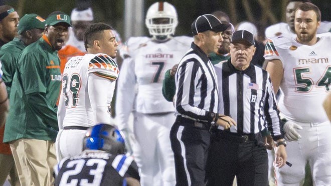 Officials confer on the field following a controversial kickoff return, with eight laterals, that ended in a touchdown to end the game and give Miami the win, 30-27, over Duke in an NCAA college football game, in Durham, N.C., Saturday, Oct. 31, 2015. A penalty for a block in the back was called during the play, and one player appeared to be down before a lateral, but the play was allowed to stand as a touchdown. On Sunday, Nov. 1, 2015, the ACC announced that the officiating and replay crew has been suspended for two games for mistakes made during the play. (AP Photo/Rob Brown)