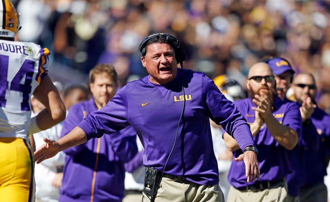 LSU interim head coach Ed Orgeron cheers from the sideline after a score in the first half against Florida in Baton Rouge, La. Florida won 16-10.