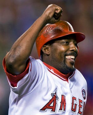FILE - In this Aug. 10, 2009, file photo, Los Angeles Angels' Vladimir Guerrero celebrates hitting his 400th career home run in the seventh inning of a baseball game against the Tampa Bay Rays, in Anaheim, Calif. Steroids-tainted stars Manny Ramirez and Ivan Rodriguez are on baseball's Hall of Fame ballot for the first time along with Vladimir Guerrero. (AP Photo/Mark Avery, File)