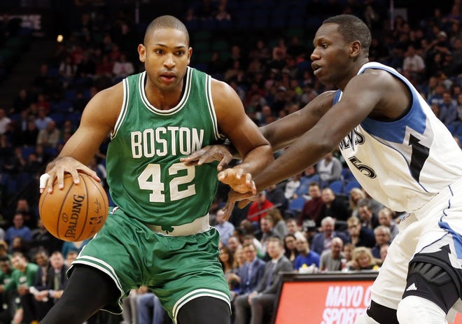 Boston Celtics' Al Horford, left, drives against Minnesota Timberwolves forward Gorgui Diang during their game in Minneapolis on Monday night. Photo by AP