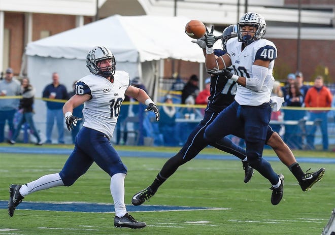 University of New Hampshire defensive back Pop Lacey (40) intercepts a pass as teammate Rick Ellison (16) looks on during Saturday's 24-21 win over Maine in Orono, Maine. Lacey would return the pick 44 yards for a touchdown. Courtesy photo
