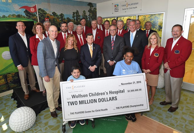 Wolfson Children’s Hospital patients Jacob Lopez (left) and Raia Adams hold a $2 million check The Players Championship gave The Players Center for Child Health at the Jacksonville hospital Monday. Behind them are golfer Jim Furyk (from left) and wife Tabitha Furyk, chairman-elect of the Baptist Foundation; Wolfson’s hospital president Michael Aubin; Baptist Health president/CEO Hugh Greene; and Matt Rapp, executive director of The Players Championship. (Provided by Chris Condon/PGA TOUR)