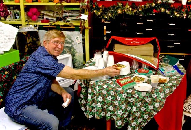 Tom McNicholas, owner of the Oak Haven Party Store, was on hand at the Blossom Shop's Salvation Army benefit to provide pizza, beer and wine. ANDREW KING PHOTO