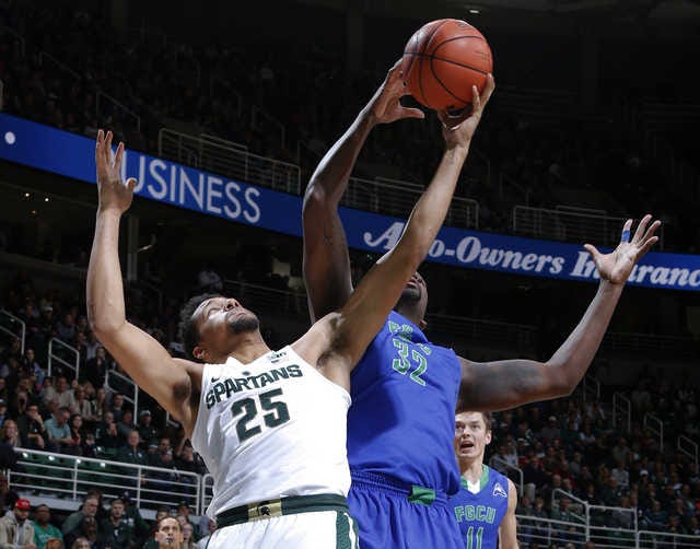 Michigan State's Kenny Goins (25) and Florida Gulf Coast's Antravious Simmons reach for a rebound during the first half of an NCAA college basketball game, Sunday, Nov. 20, 2016, in East Lansing, Mich. (AP Photo/Al Goldis)
