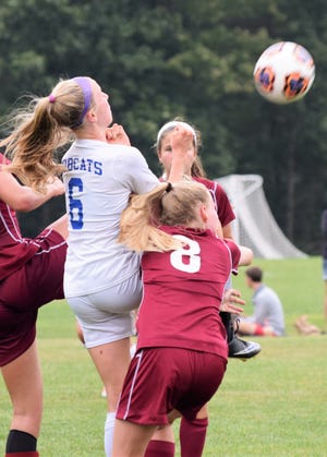 Junior Eleanor Zwart of Oyster River High School (6), shown going up for a header in a game against Portsmouth this season, was selected to the All-Division II first team on Monday. Mike Zhe photo