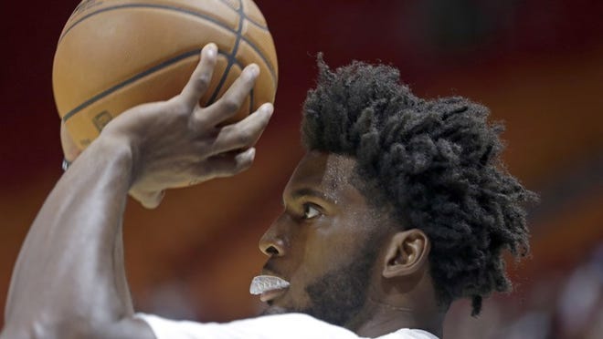 Miami Heat forward Justise Winslow warms up before the NBA basketball team's Red, White and Pink annual Scrimmage, Monday, Oct. 10, 2016, in Miami. (AP Photo/Alan Diaz)