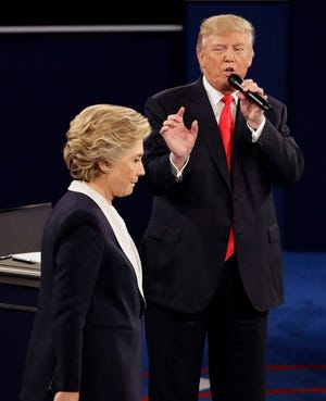 Democratic presidential nominee Hillary Clinton walks past Republican presidential nominee Donald Trump during the second presidential debate Oct. 9 at Washington University in St. Louis.