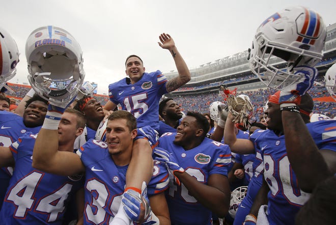 Florida place kicker Eddy Pineiro (15) sits on the shoulders of his teammates as they celebrate after defeating South Carolina 20-7 on Nov. 12 in Gainesville. Pineiro kicked two field goals in the game, including one for 54-yards. John Raoux / AP
