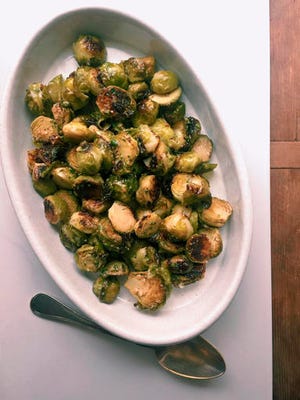 Katie Workman via AP - This October 2016 photo shows a warm Brussels sprouts salad with anchovy vinaigrette in New York. This dish is from a recipe by Katie Workman.