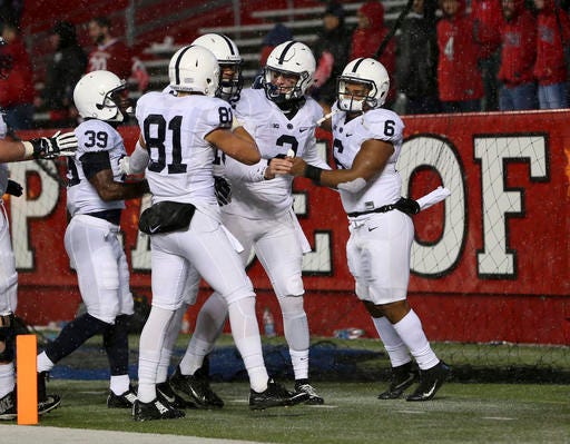 Penn State quarterback Tommy Stevens, second from right, celebrates with his teammates after scoring a touchdown during the second half of an NCAA college football game against Rutgers on Saturday, Nov. 19, 2016, in Piscataway, N.J. Penn State won 39-0. (AP Photo/Mel Evans)