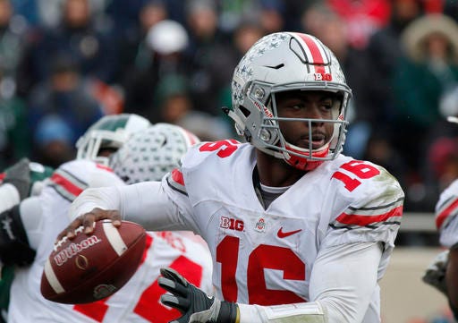 Ohio State quarterback J.T. Barrett looks to throw against Michigan State during the fourth quarter half of an NCAA college football game, Saturday, Nov. 19, 2016, in East Lansing, Mich. Ohio State won 17-16. (AP Photo/Al Goldis)