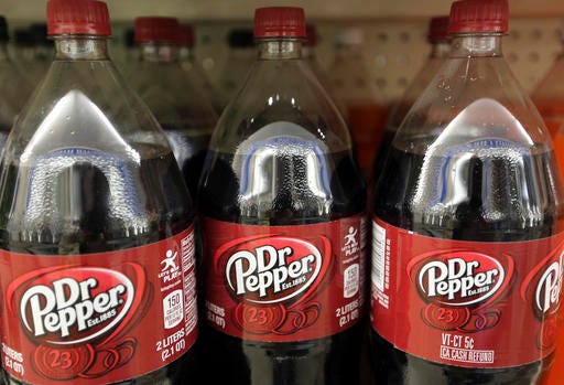 FILE - This Thursday, April 28, 2016, file photo shows bottles of Dr. Pepper on a store shelf at Quality Cash Market in Concord, N.H. Dr Pepper Snapple Group Inc. announced Tuesday, Nov. 22, 2016, the company is paying $1.7 billion for Bai Brands, a fruity drink maker that counts pop star Justin Timberlake as an investor. (AP Photo/Jim Cole, File)
