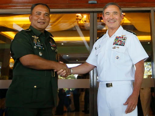 U.S. Admiral Harry Harris, right, U.S. Commander of the U.S. Pacific Command, poses with Philippine Armed Forces Chief Gen. Ricardo Visaya for a photo following their annual Mutual Defense Board meeting at Camp Aguinaldo in suburban Quezon city, northeast of Manila, Philippines Tuesday, Nov. 22, 2016. The annual meeting came at a time when Philippine President Rodrigo Duterte ordered the scaling down joint military exercises and other activities between the two countries. (AP Photo/Bullit Marquez)