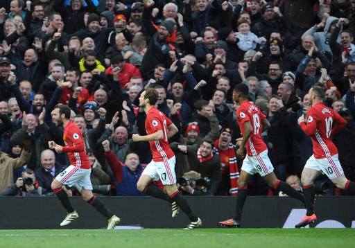 Manchester United's Juan Mata, left, leads celebrations after scoring against Arsenal during the English Premier League soccer match between Manchester United and Arsenal at Old Trafford in Manchester, England, Saturday, Nov. 19, 2016. (AP Photo/Rui Vieira)