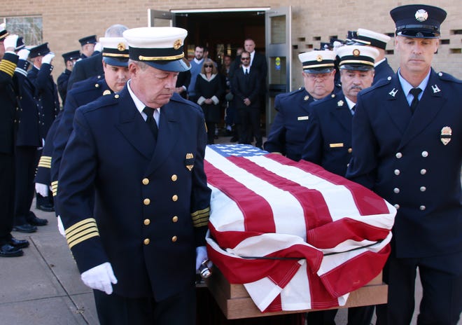 York Beach firefighters carry the flag-draped casket of Samuel Horn, a member of the of the York Beach Fire Department for 48 years, following a funeral Mass at St. Christopher Church in York, Maine, on Thursday. Photo by Rich Beauchesne/Seacoastonline