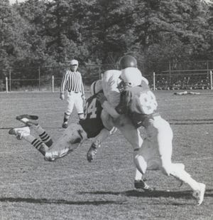Falmouth and Barnstable players (in dark jerseys) collide, resulting in a Clippers interception during the 1986 Thanksgiving Day high school matchup. Falmouth won the game 33-12. Barnstable Patriot Files/W.B. Nickerson Cape Cod History Archives