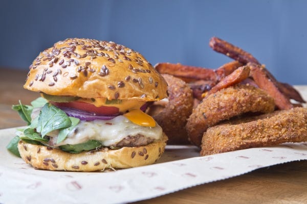The Fire Quacker with sweet potato fries and onion rings at Bareburger