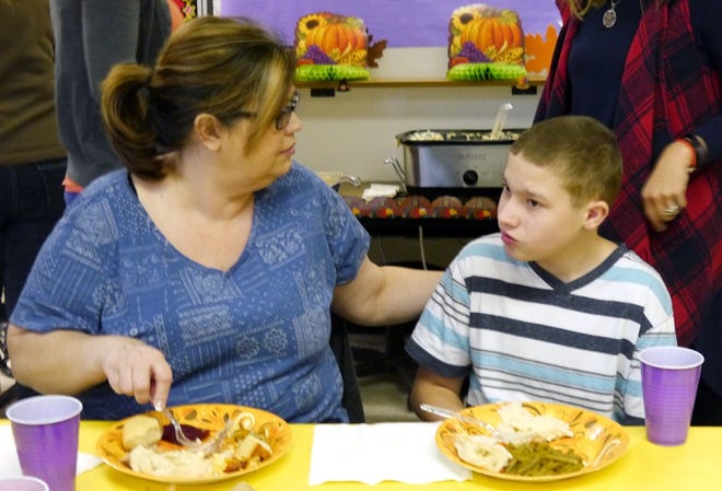 Dawn and Jordan Tinsley enjoy their meal together during Flat Rock Middle's Thankgiving feast for Exceptional Children students Tuesday.
