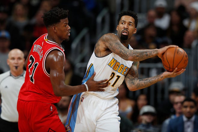 Chicago Bulls forward Jimmy Butler, left, defends against Denver Nuggets forward Wilson Chandler as he looks to pass the ball in the first half of an NBA basketball game Tuesday, Nov. 22, 2016, in Denver. (AP Photo/David Zalubowski)