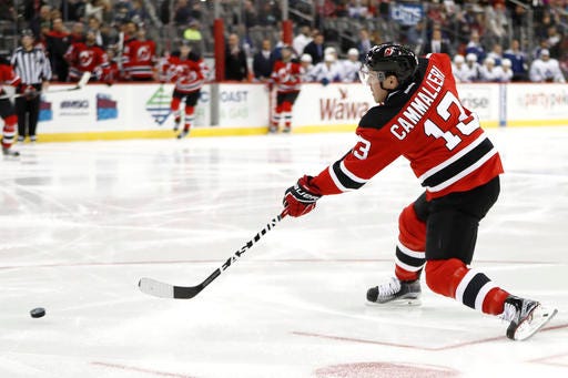 New Jersey Devils left wing Michael Cammalleri assists on a goal by center Travis Zajac, not pictured, during the second period of an NHL hockey game against the Toronto Maple Leafs, Wednesday, Nov. 23, 2016, in Newark, N.J. (AP Photo/Julio Cortez)
